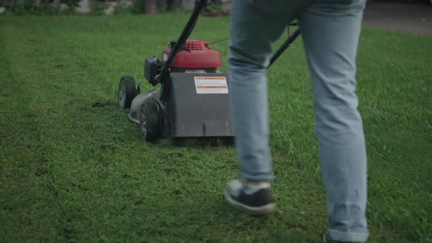 A man mows a lawn