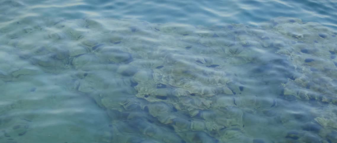 The water is clear showing rocks below