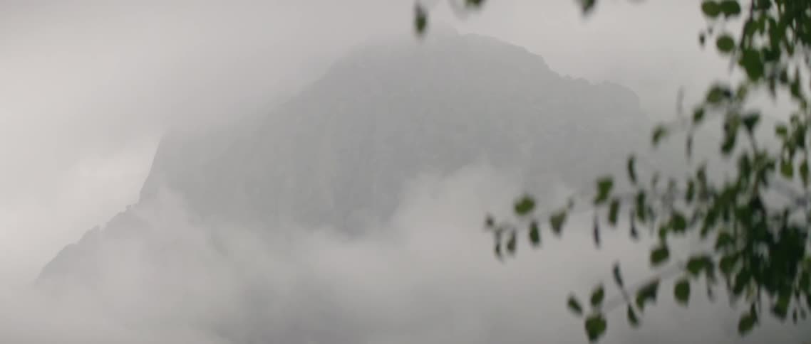 Clouds billow over mountains in the evening
