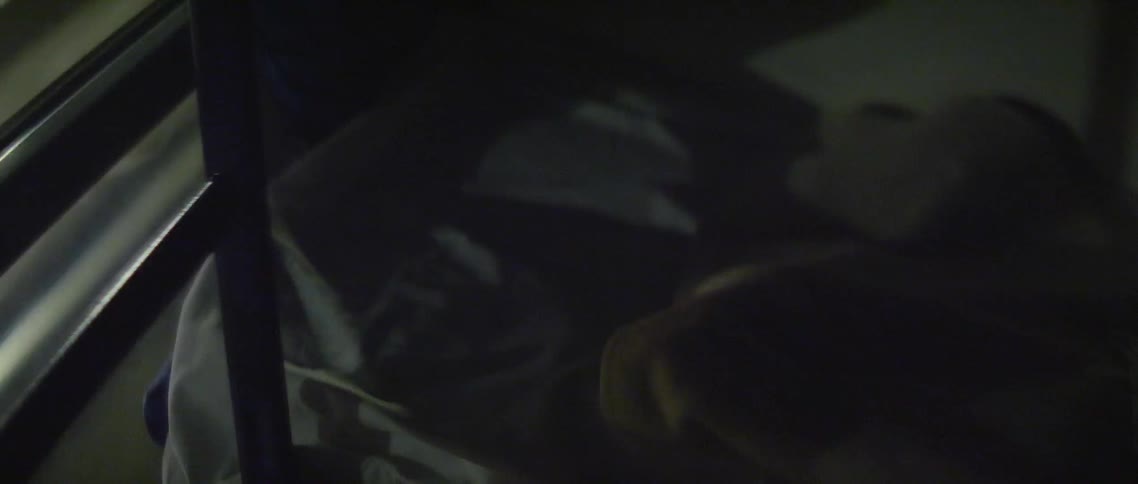 The lights shine on the bed from the window of the night train