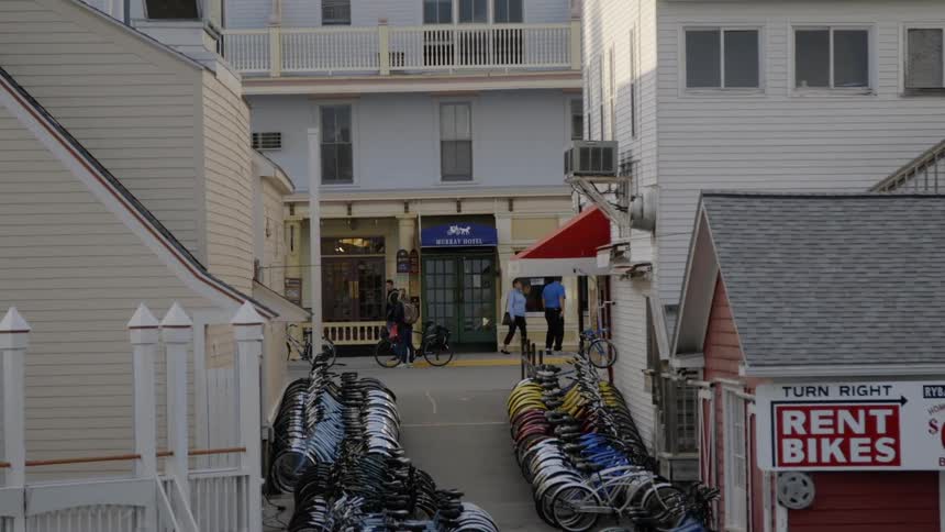 The alley is full of parked bicycles