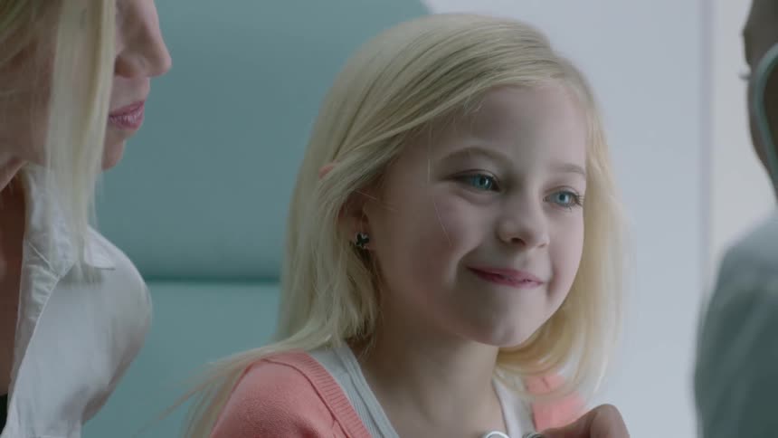 A blond mother and child in a doctor's office