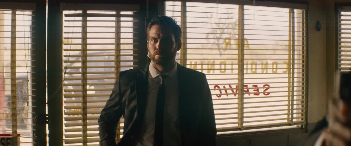 A man is pointing a gun in the store