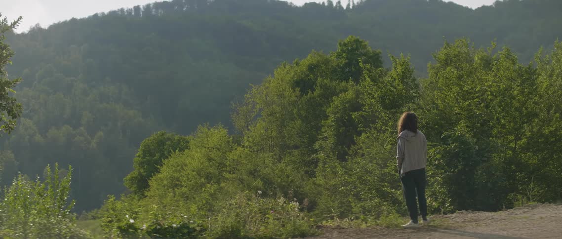 Woman standing in forest wilderness area during the day