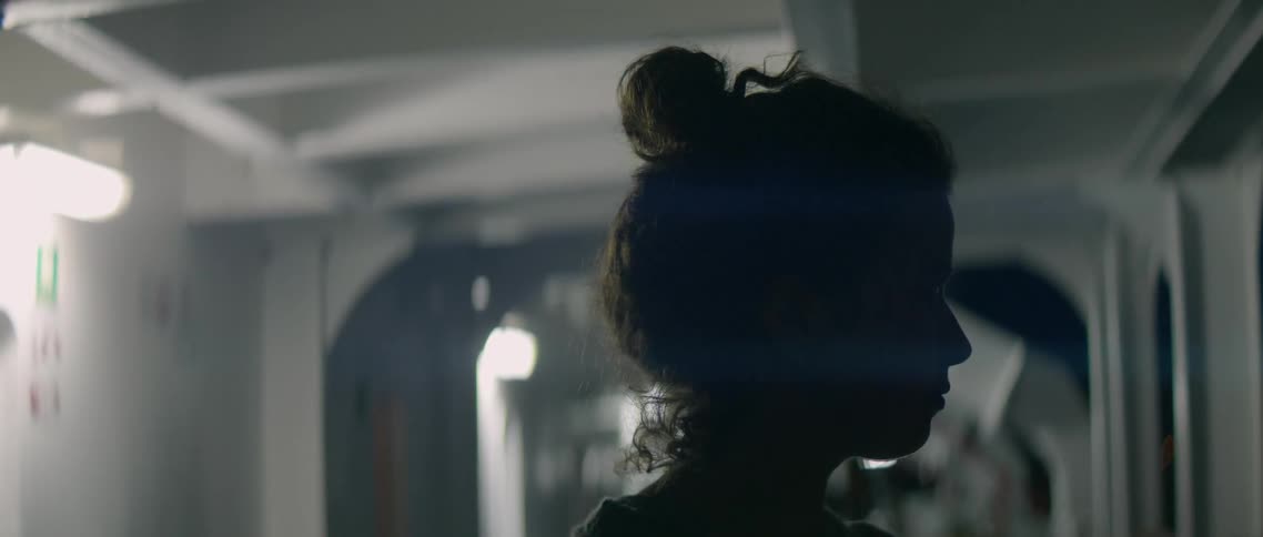 Woman on a ferry at night