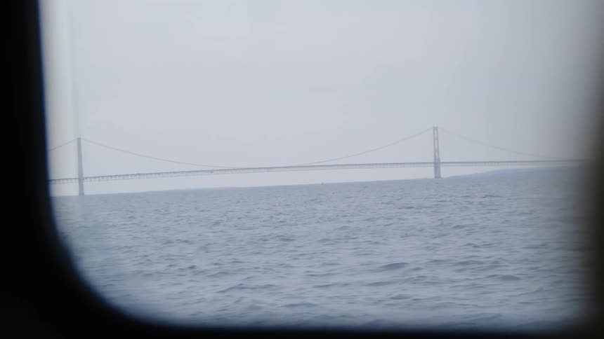 Outside the boat window is a large bridge