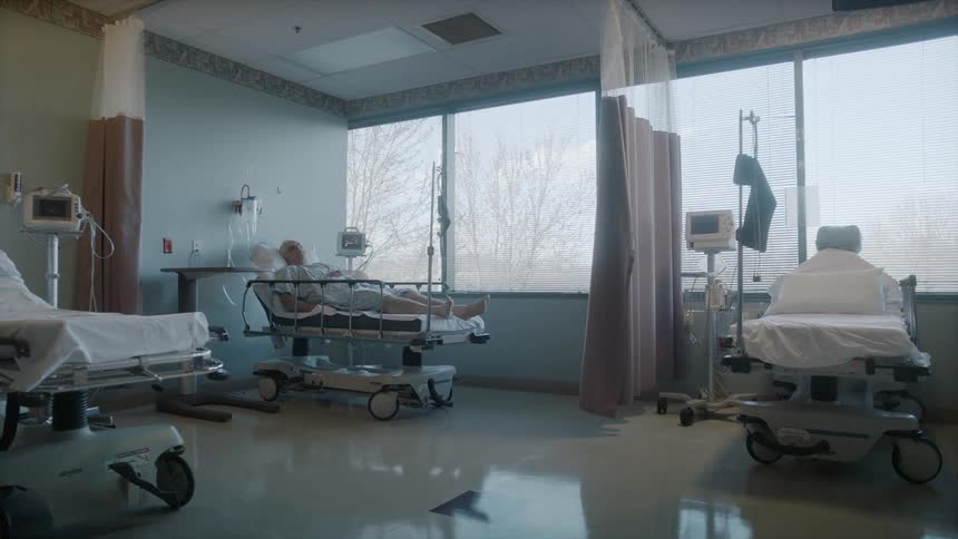 Elderly man in a hospital bed