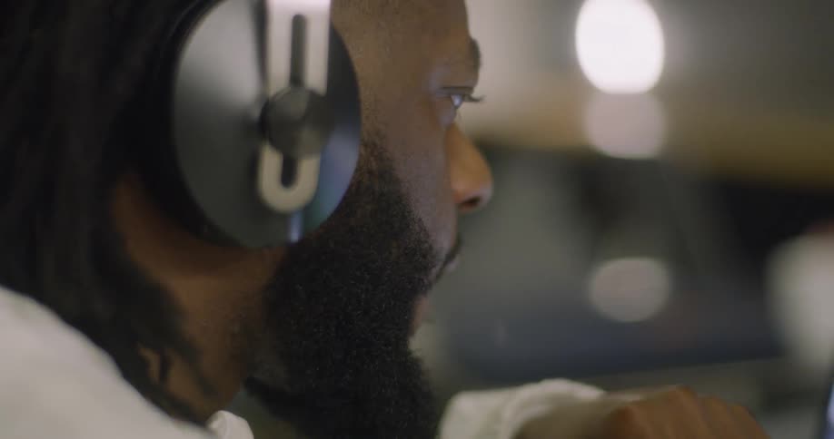 The man adjusts his headphones