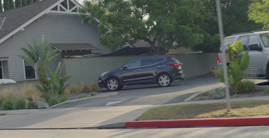 Vehicles sit parked in a residential area