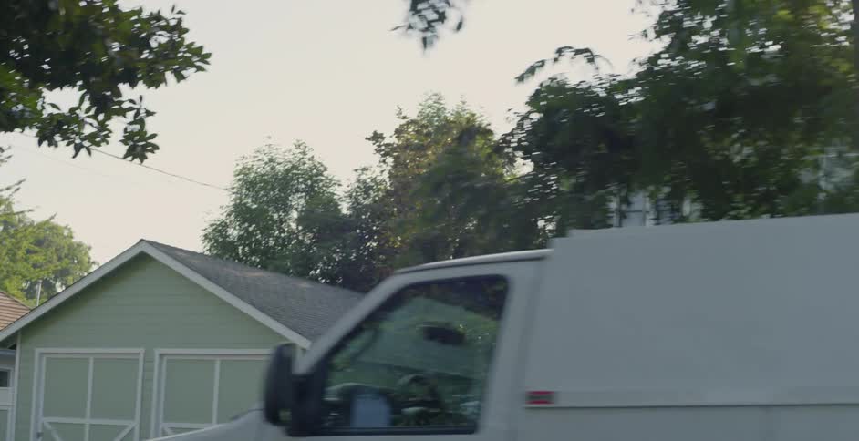 A man walks from his work truck on the street