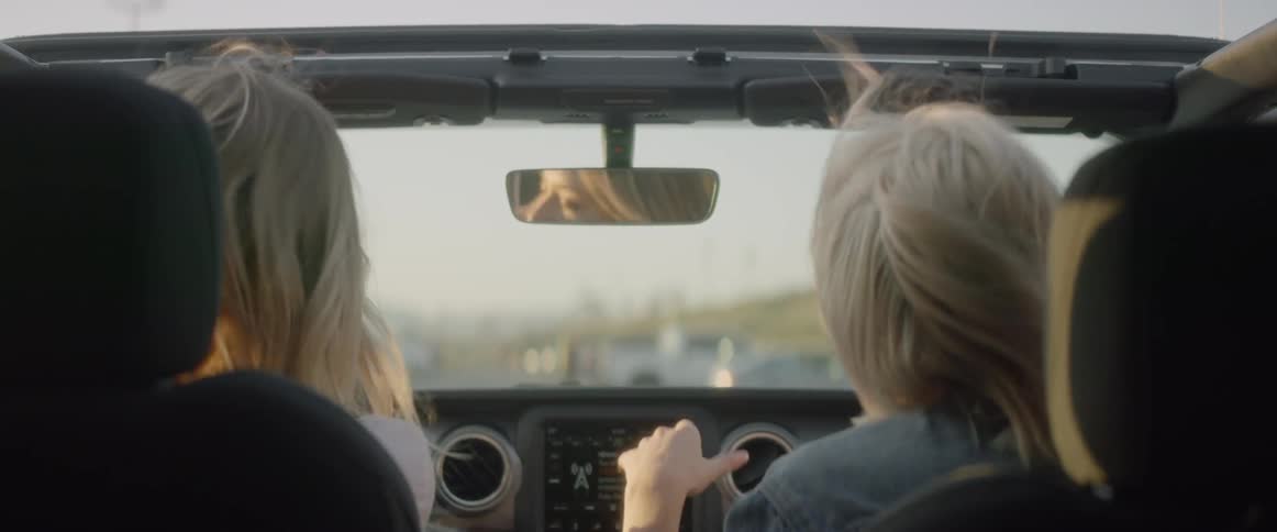 The women talk as they ride in the car