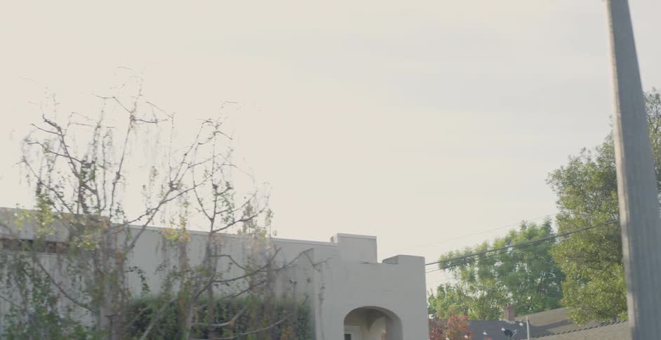 White cement buildings sit under a cloudy sky