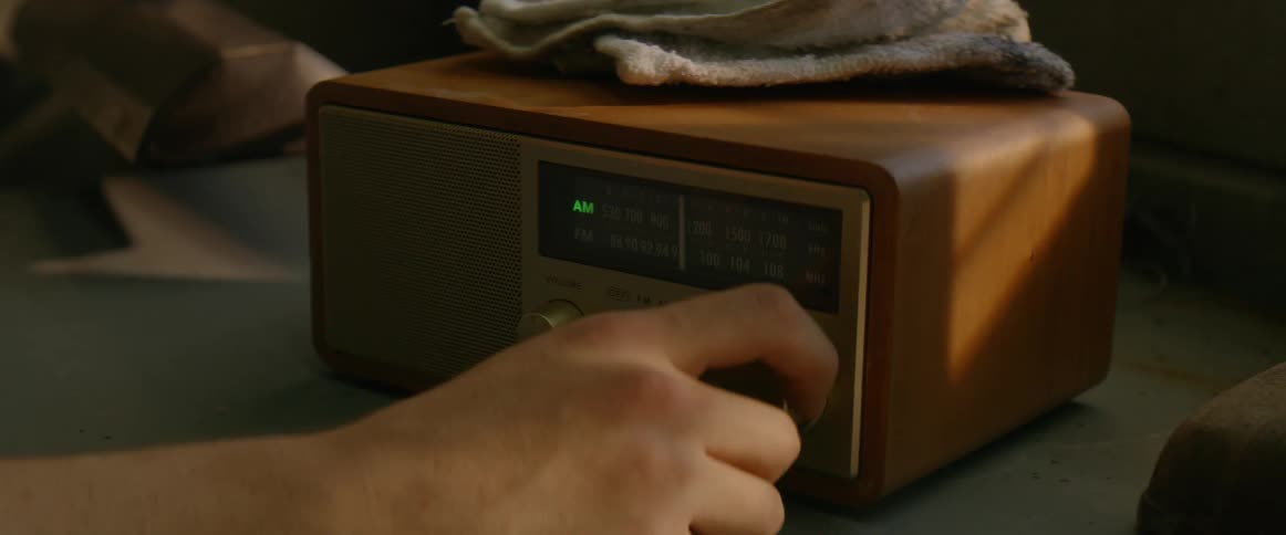 The person turns the tuner on the radio