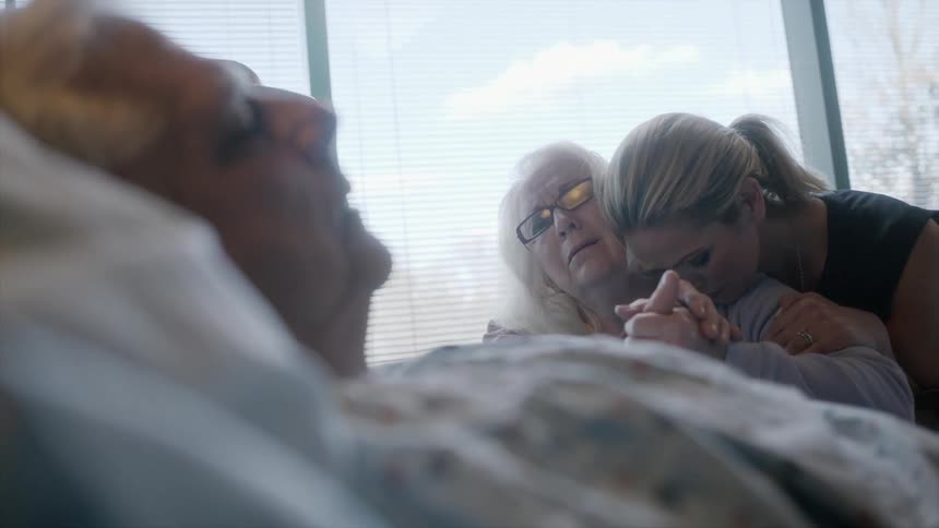 Visitors mourn over a hospital patient