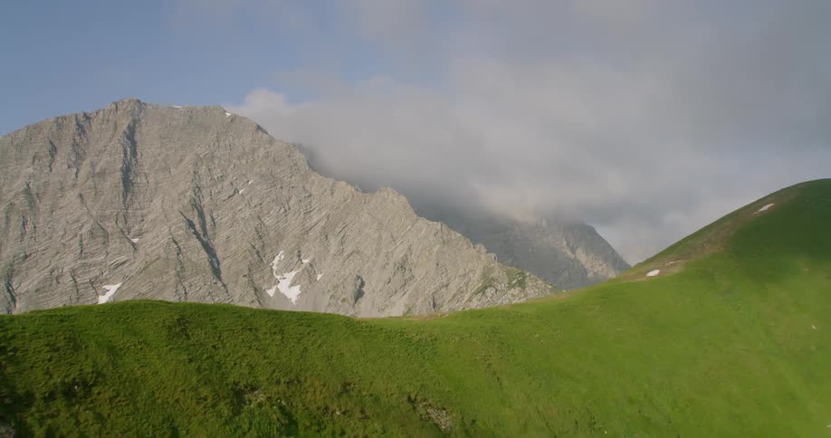 The clouds cover the tall mountains ahead