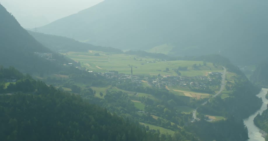 The town near the river is covered in heavy fog
