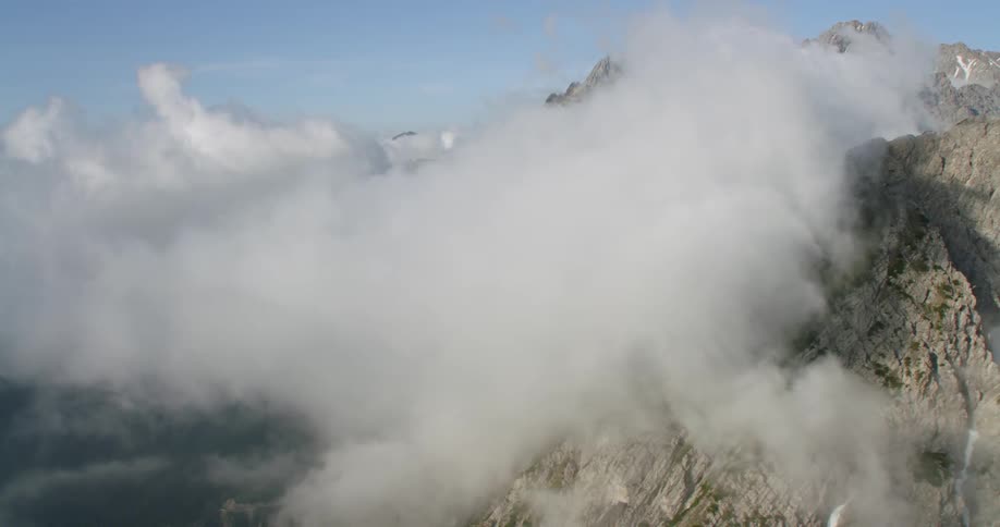 The heavy clouds cover the top of the mountains
