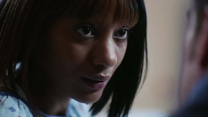 A woman looks up and speaks to a man