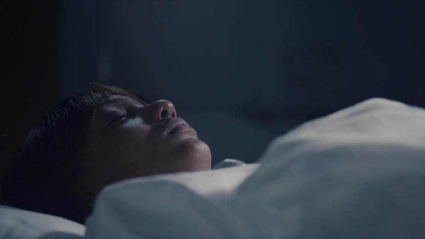 A patient lays in a hospital bed