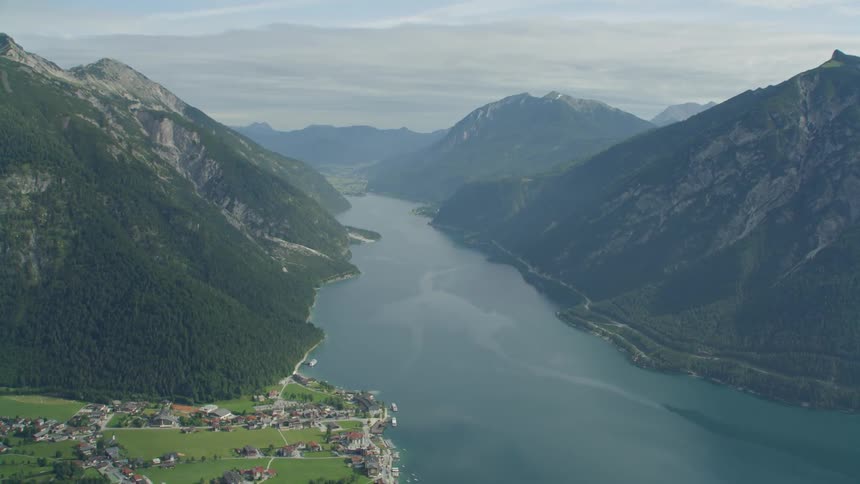 Wide river flows between mountain ranges