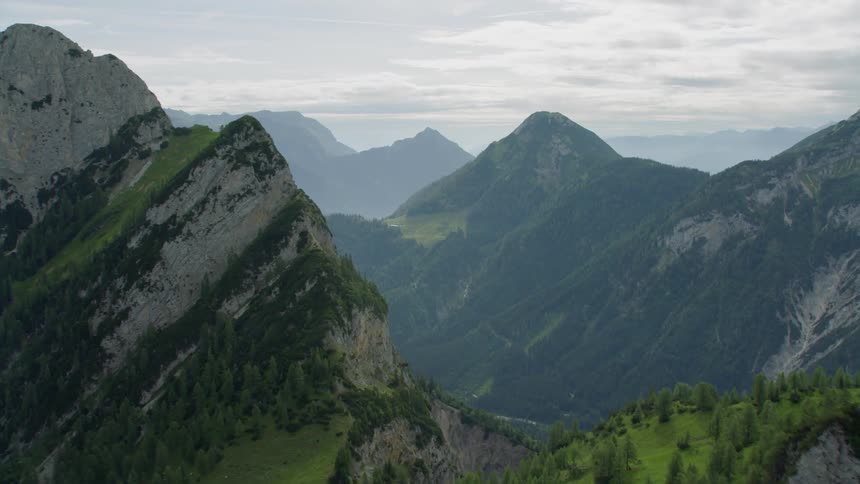 The tall mountain range has a river running down the middle below