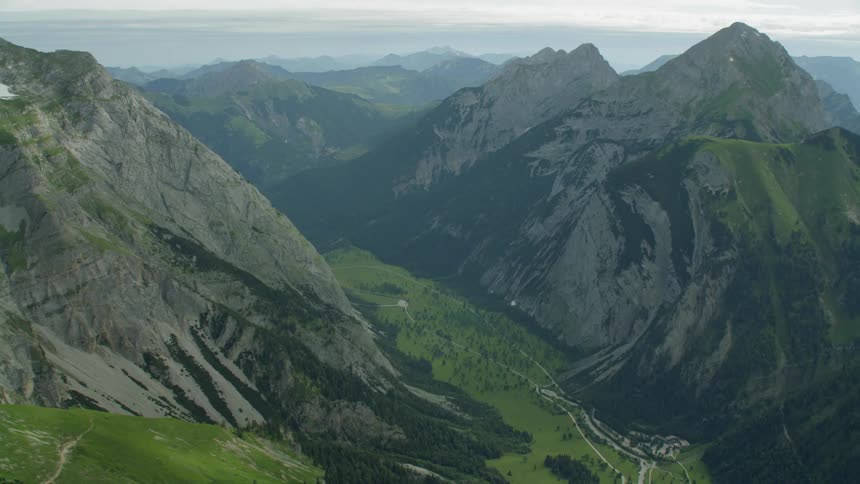 The mountains are covered with green and fog