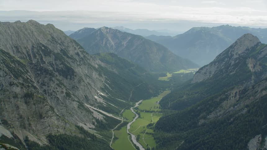 Canyon river running through mountains on cloudy day