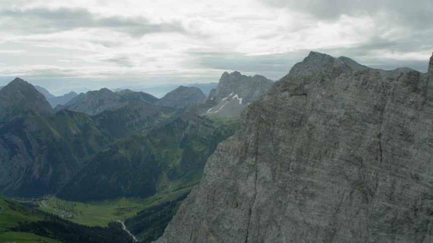 Tall rocky cliffs with clouds hanging overhead