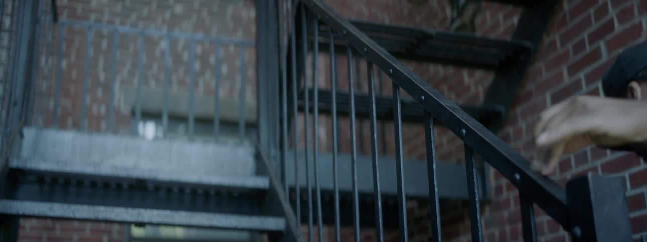 The man races down the stairs being chased