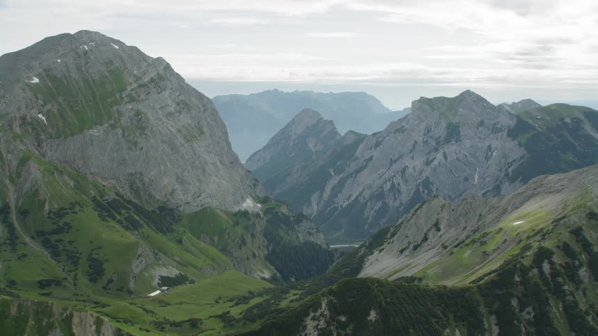 The green mountain range has fog ahead