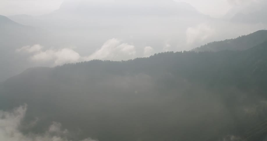 The hills and mountains are covered with clouds and fog