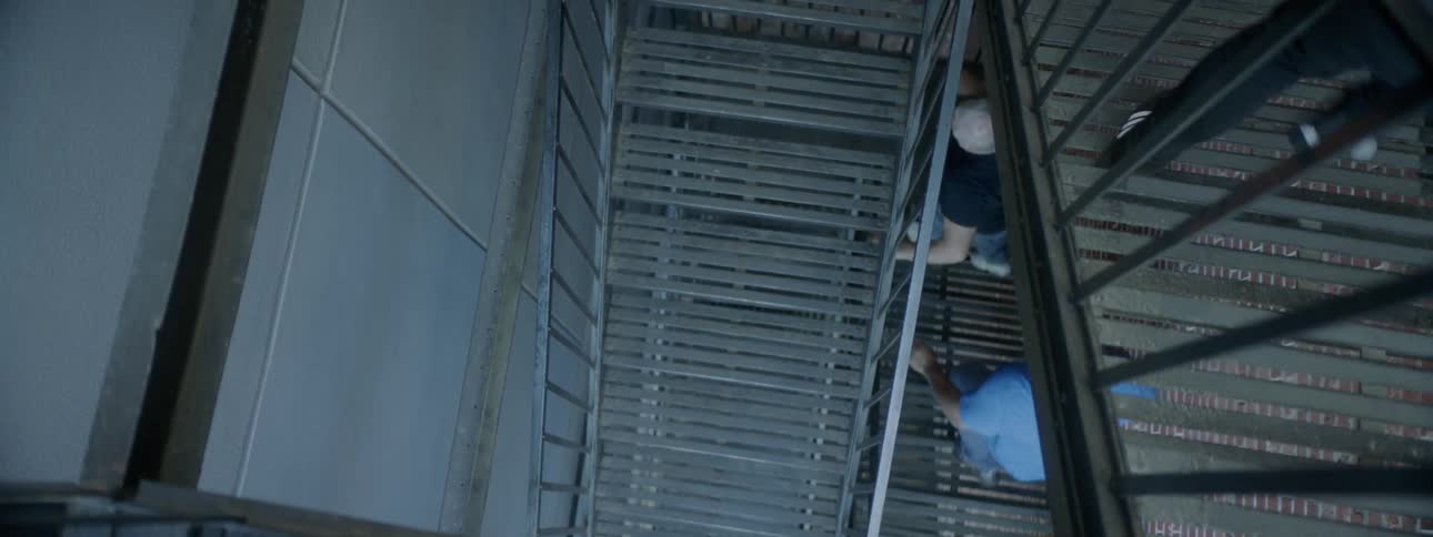 The men run down the metal staircase