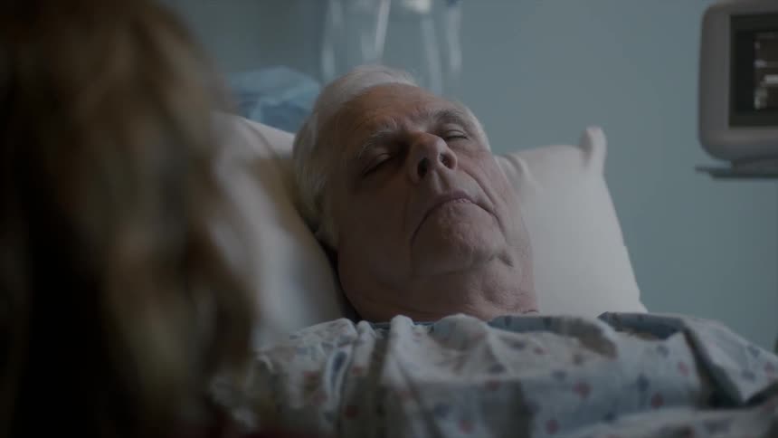 Elderly man sleeping on a hospital bed