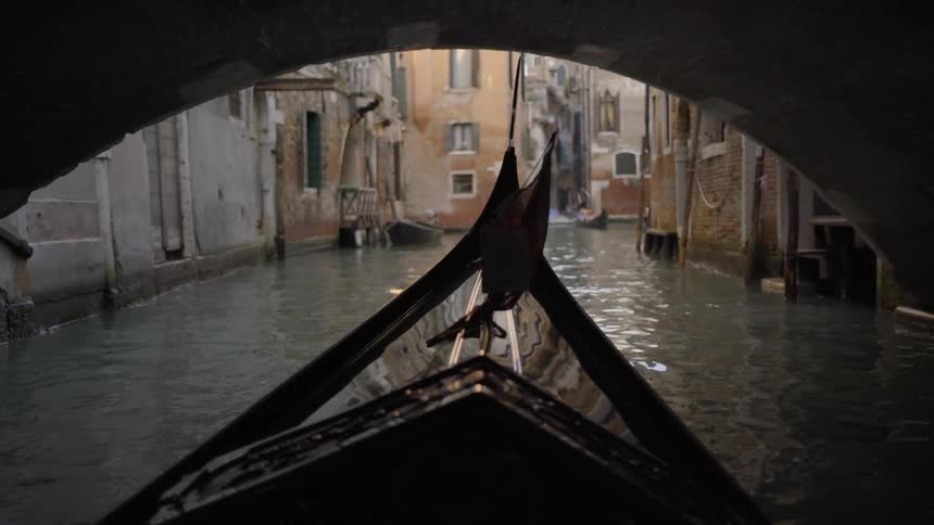 A boat floats down a city canal