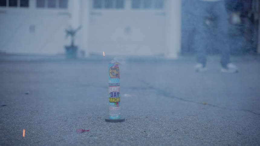 Man stands near an exploding firework