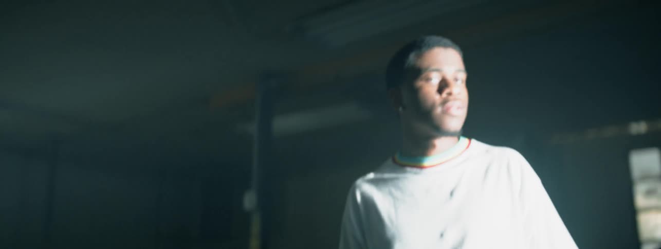 The man walks forward into the light