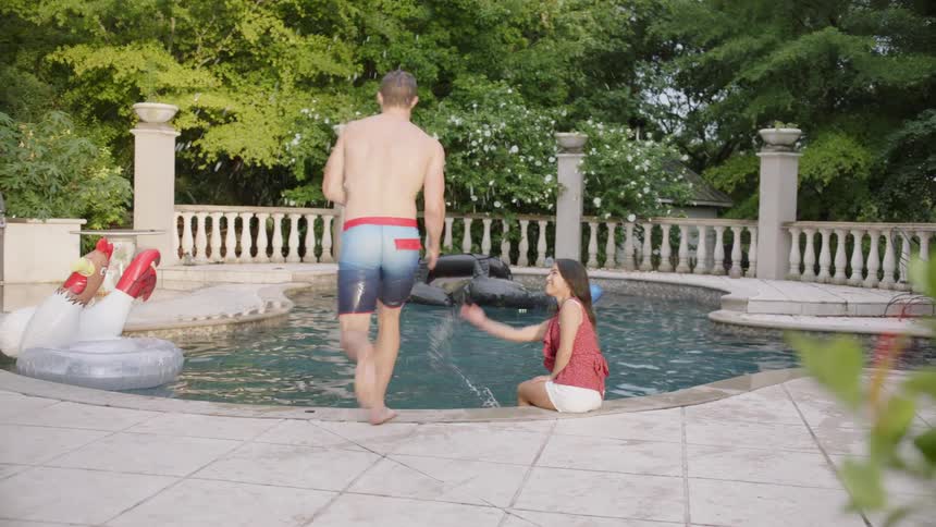 The man runs and jumps in doing a cannonball
