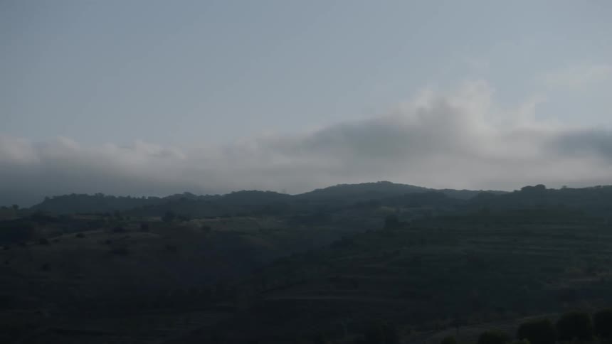 Clouds float over mountains in the wilderness