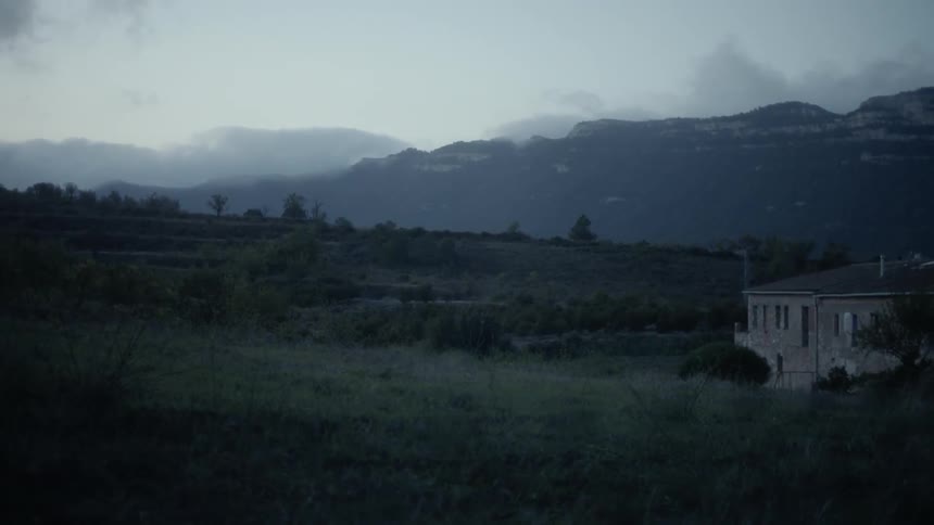 Clouds float above mountains in a rural area