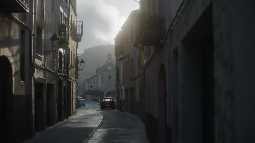 Narrow street in foreign town on cloudy day