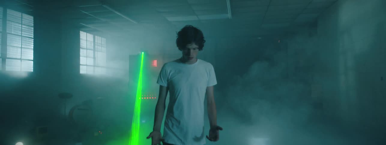 The man walks from the fog in the dark room