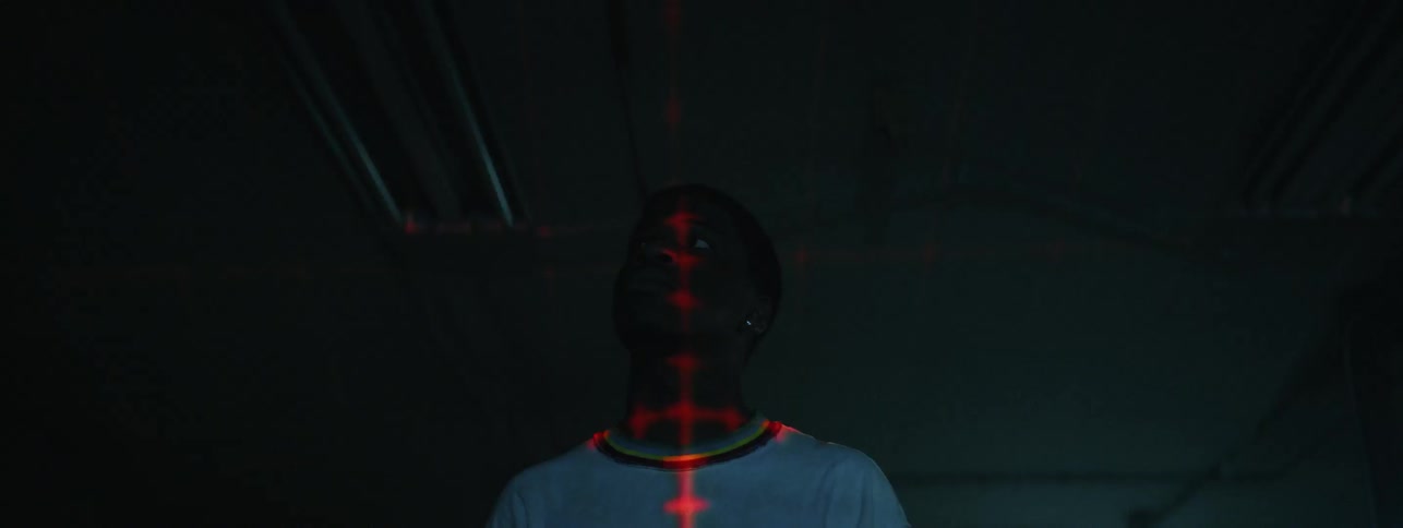 Man with laser grid on shirt stares at strobe light