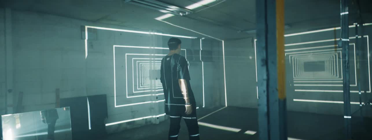 The man walks and waves his arms around in the lights