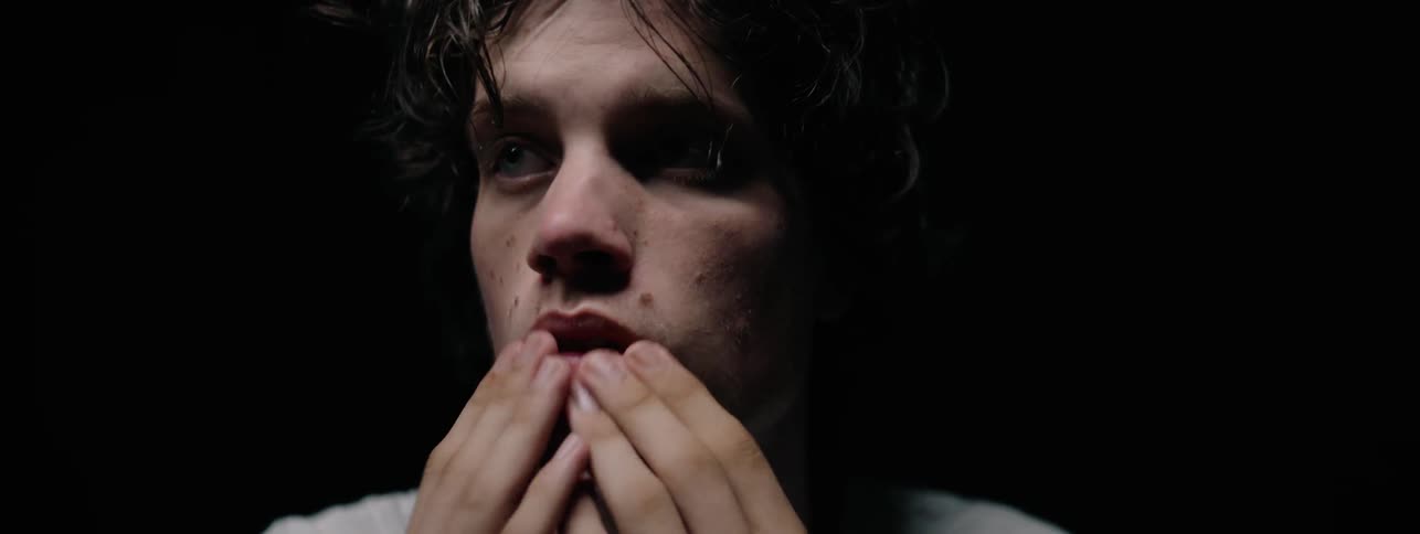 The man removes the hands from his face