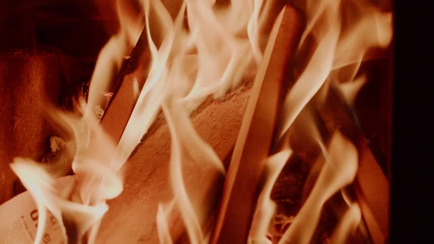 Flames burn paper and wood