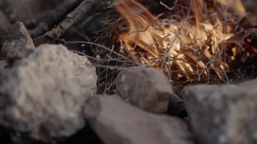 Fire pit made of rocks quickly burns twigs