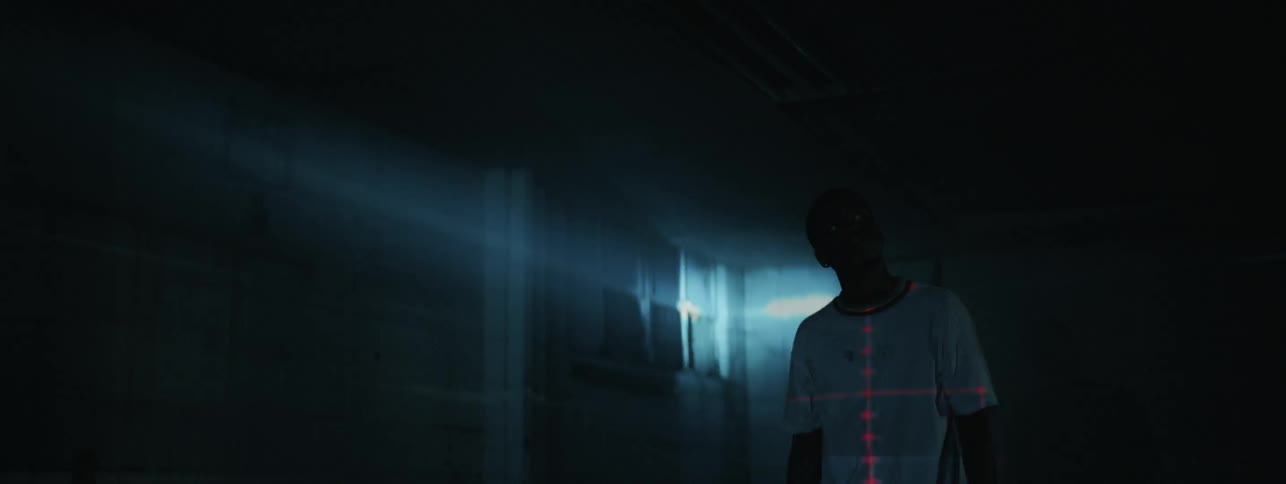 Man stands gazing into strobe light