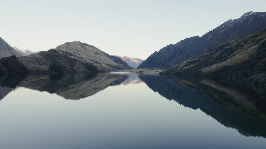 Lake reflects surrounding mountains