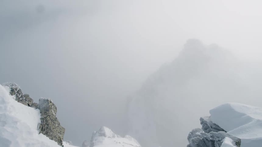 Snow covered mountains under a cloudy sky