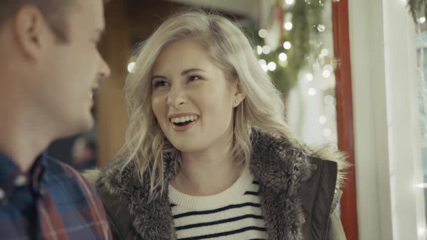 Smiling woman talking to a smiling man